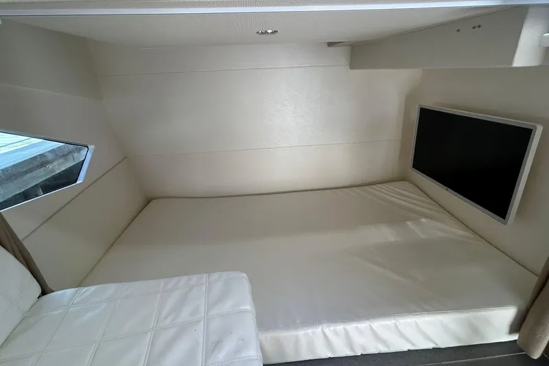 Slide: The Image of Interior of 2021 Evolve 360HT showing a cozy cabin with a bed and TV. - 69