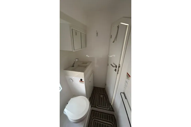 Slide: The Image of Compact bathroom in 2021 Evolve 360HT with toilet, sink, and mirror cabinet. - 75