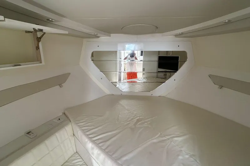 Slide: The Image of Interior of 2021 Evolve 360HT yacht with white cushioned seating and mirrored wall. - 77