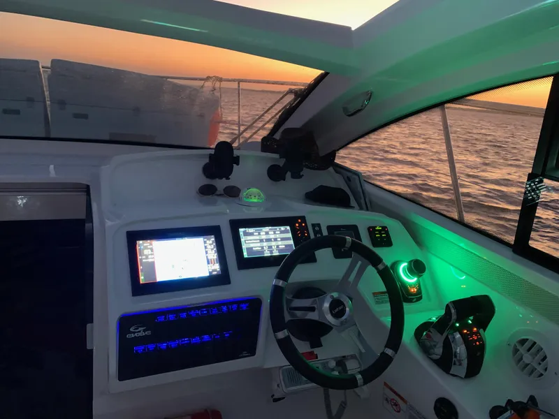 Slide: The Image of Helm of 2022 Evolve 360HT boat at sunset, featuring modern navigation controls. - 8