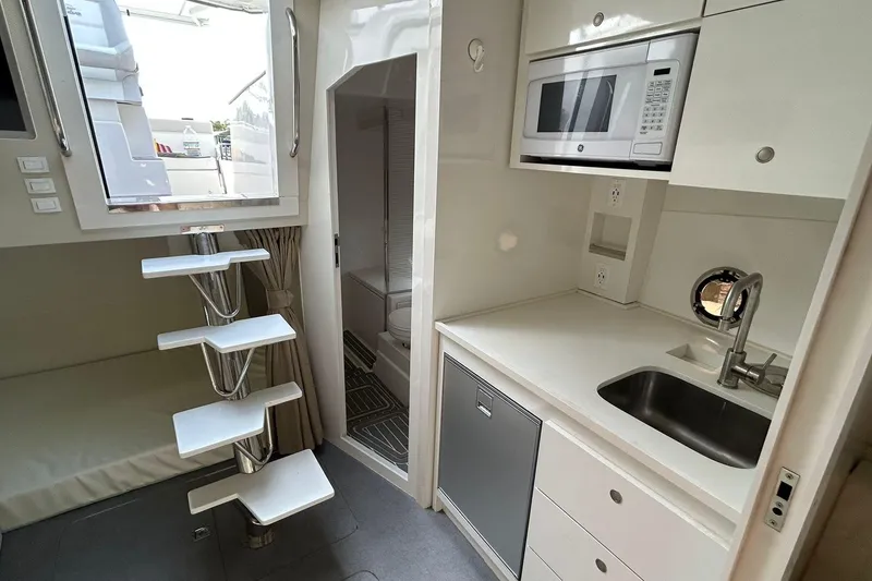 Slide: The Image of Modern 2021 Evolve 360HT yacht interior with compact kitchen and sleek staircase design. - 83