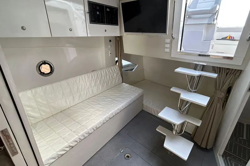 Slide: The Image of Modern interior of 2021 Evolve 360HT yacht with white seating and sleek staircase. - 84