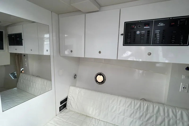 Slide: The Image of Interior of 2021 Evolve 360HT yacht with white cabinetry and control panels. - 85