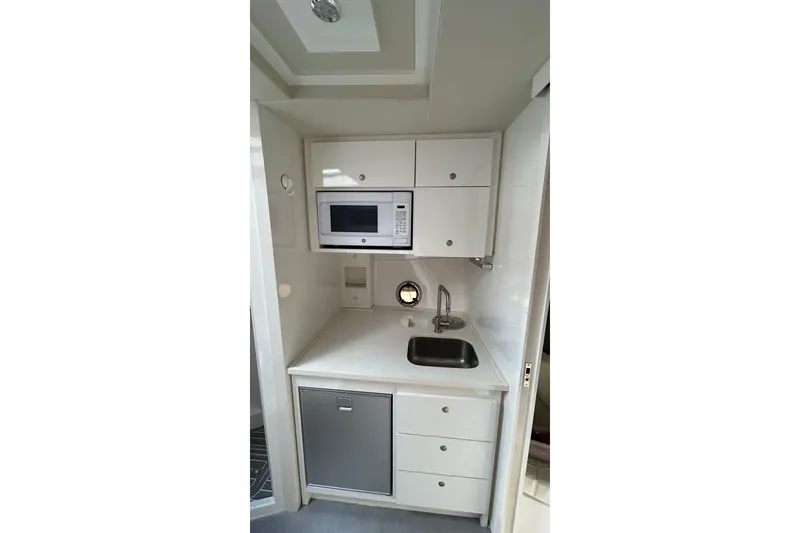 Slide: The Image of Compact kitchenette in 2021 Evolve 360HT with microwave, sink, and storage cabinets. - 86
