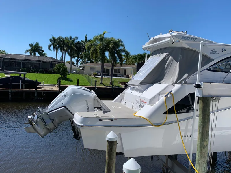 Slide: The Image of Evolve 360HT 2022 boat docked by waterfront with palm trees in background. - 18