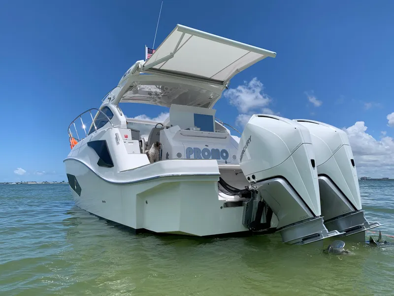 Slide: The Image of 2022 Evolve 360HT boat with dual engines, anchored in clear water under a blue sky. - 19