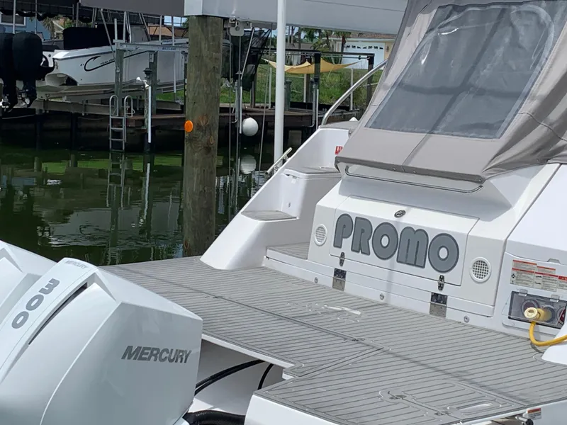 Slide: The Image of 2022 Evolve 360HT boat with Mercury engines docked at marina. - 5