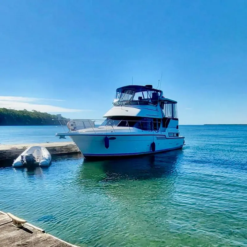 Slide: The Image of 1994 Carver 390 Cockpit Motor Yacht docked on clear blue water. - 3