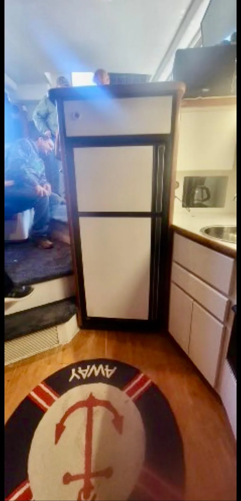 Slide: The Image of Interior of 1994 Carver 390CPMY yacht with kitchenette and nautical-themed rug. - 8