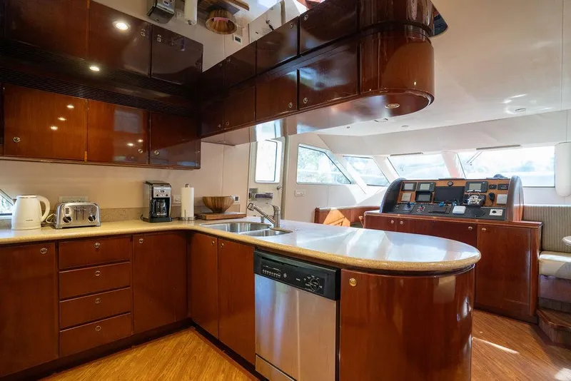 Slide: The Image of Luxurious kitchen interior of 2004 Cheoy Lee 84 Bravo Flybridge yacht with wood cabinetry. - 11