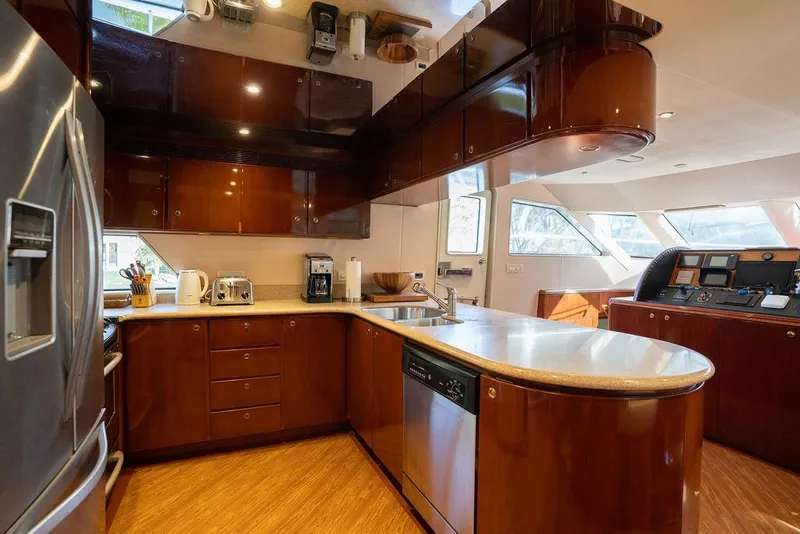 Slide: The Image of Luxurious kitchen interior of 2004 Cheoy Lee 84 Bravo Flybridge yacht with modern appliances. - 12