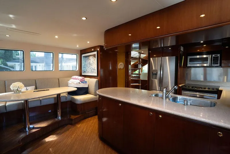 Slide: The Image of Luxurious interior of 2004 Cheoy Lee 84 Bravo Flybridge yacht with modern kitchen and dining area. - 17