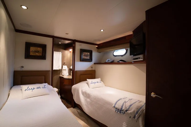 Slide: The Image of Twin cabin interior of 2004 Cheoy Lee 84 Bravo Flybridge yacht, featuring cozy beds and decor. - 26