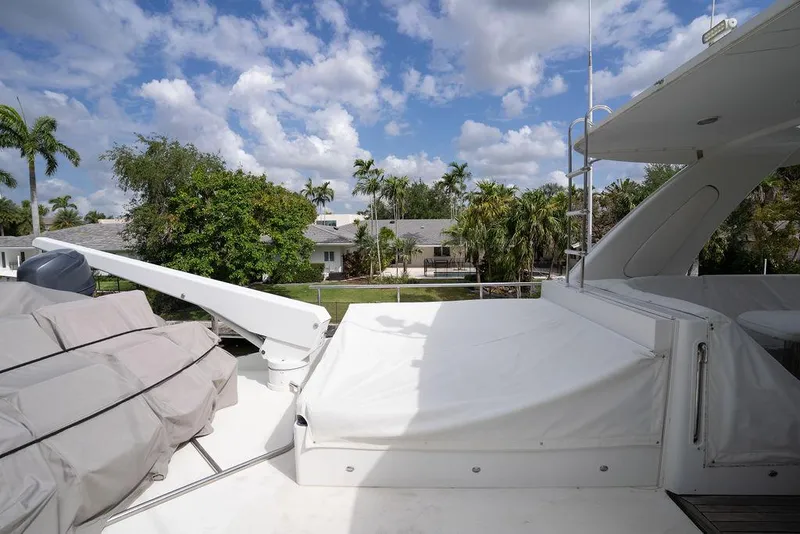 Slide: The Image of 2004 Cheoy Lee 84 Bravo Flybridge yacht deck with scenic view of palm trees and houses. - 41