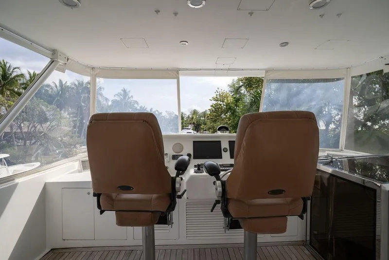 Slide: The Image of 2004 Cheoy Lee 84 Bravo Flybridge helm with dual captain chairs and panoramic view. - 44