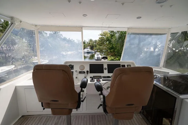 Slide: The Image of 2004 Cheoy Lee 84 Bravo Flybridge helm with dual seats and navigation equipment. - 45