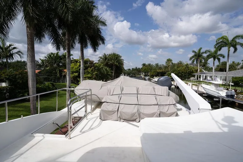 Slide: The Image of 2004 Cheoy Lee 84 Bravo Flybridge yacht deck with palm trees and blue sky. - 47