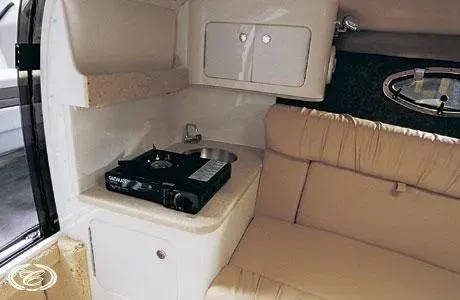 Slide: The Image of 2003 Cobalt 263 interior with compact kitchen and seating area. - 11