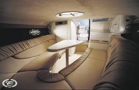 Slide: The Image of Interior of a 2003 Cobalt 263 boat with beige seating and a central table. - 12