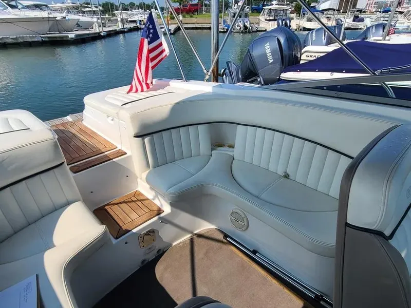 Slide: The Image of Luxury seating on a 2003 Cobalt 263 boat with American flag, docked at marina. - 4