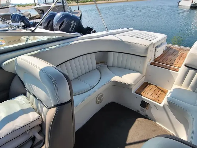 Slide: The Image of Luxurious seating on a 2003 Cobalt 263 boat, featuring white upholstery and wooden accents. - 5