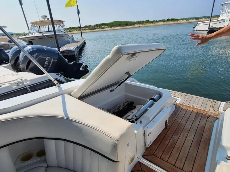 Slide: The Image of Open storage compartment on 2003 Cobalt 263 boat docked by the water. - 7