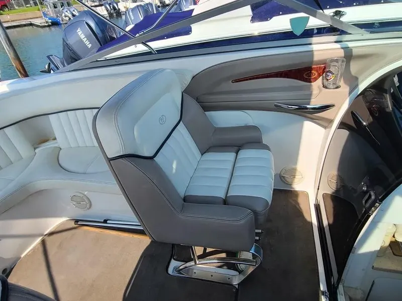Slide: The Image of 2003 Cobalt 263 boat interior with white and gray seating, docked at marina. - 9
