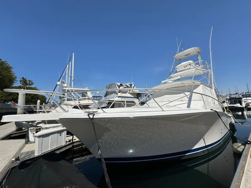 Slide: The Image of 2007 Luhrs 41 Express yacht docked at marina under clear blue sky. - 1