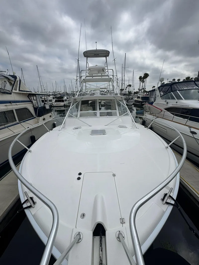 Slide: The Image of 2007 Luhrs 41 Express yacht docked in a marina under cloudy skies. - 10