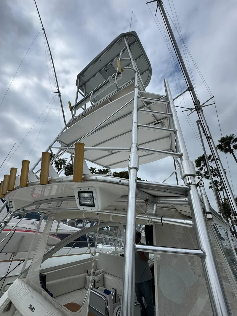 Slide: The Image of 2007 Luhrs 41 Express yacht with tower, docked under cloudy skies. - 14