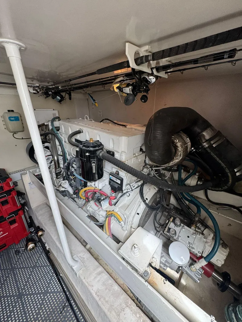 Slide: The Image of Engine room of a 2007 Luhrs 41 Express boat, showcasing mechanical components and wiring. - 21