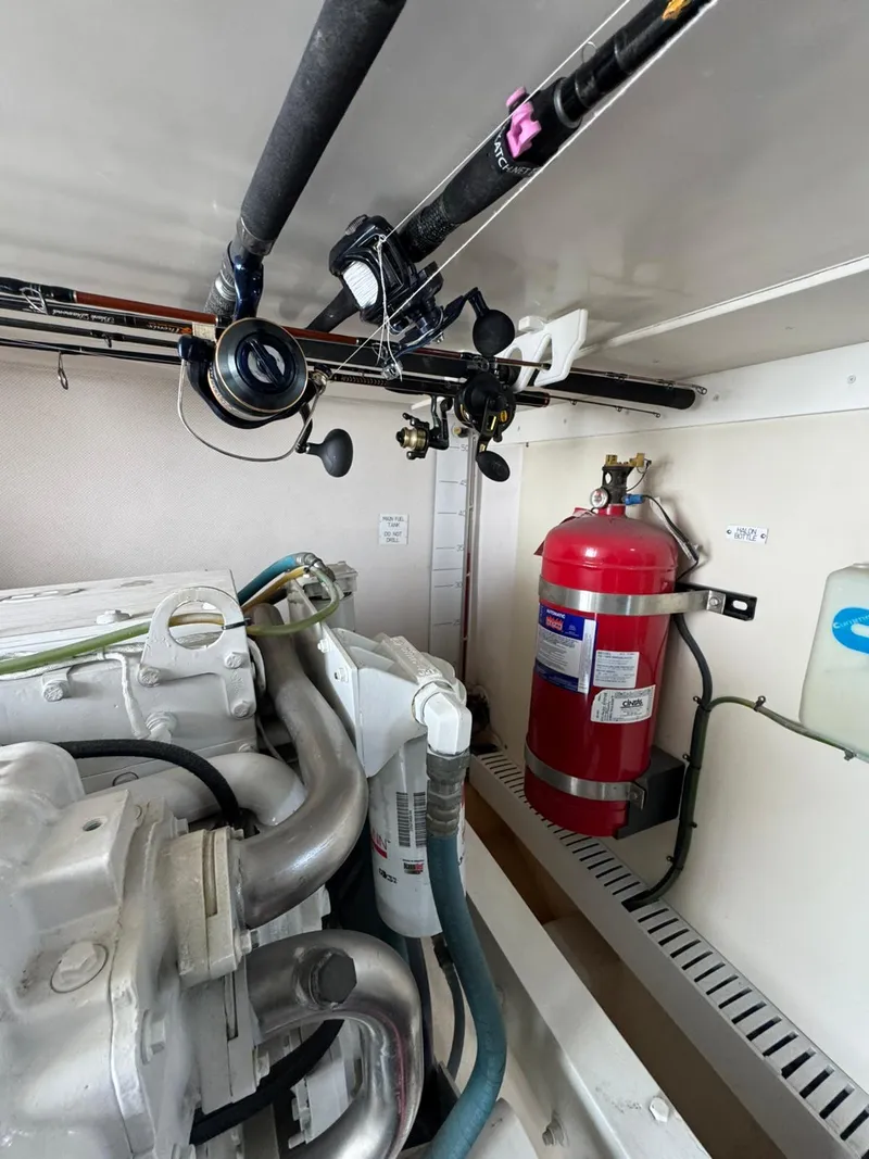 Slide: The Image of Engine room of 2007 Luhrs 41 Express with fishing rods and fire extinguisher. - 24