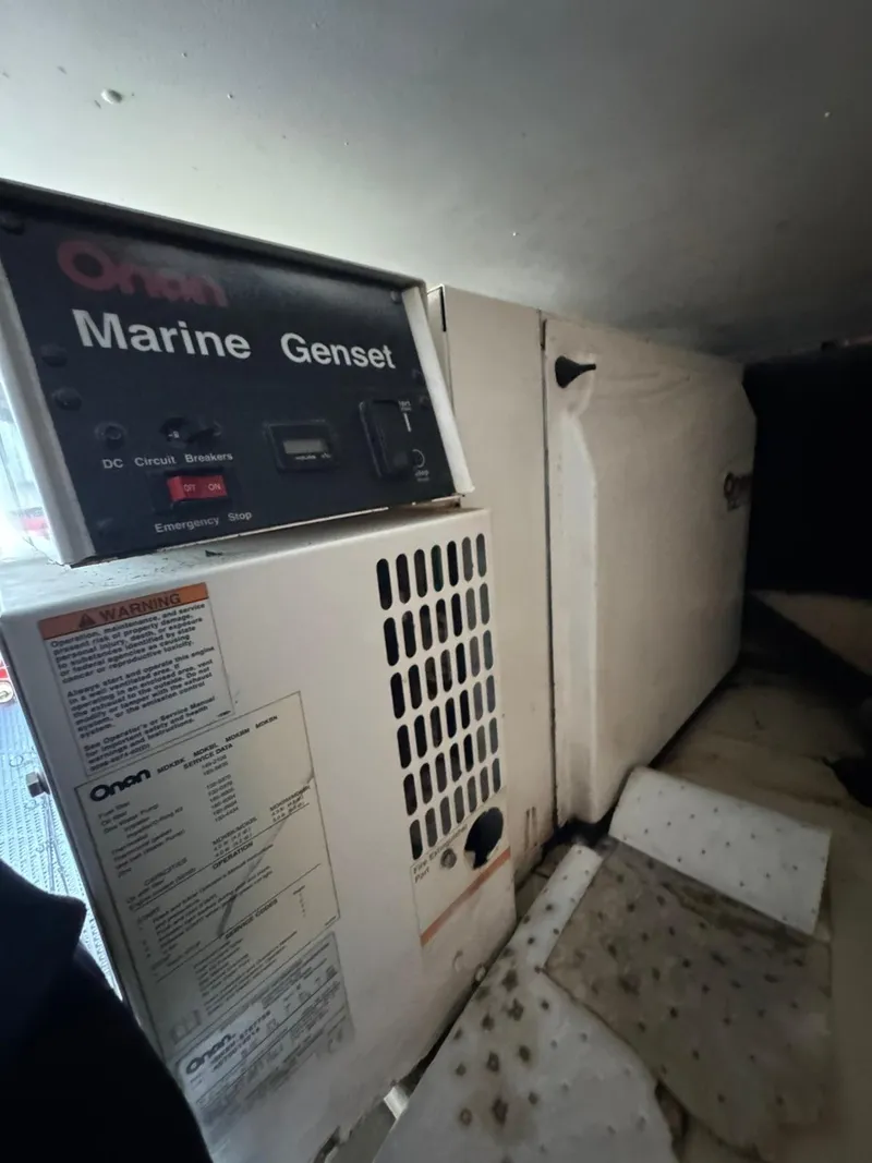 Slide: The Image of 2007 Luhrs 41 Express marine generator, Onan brand, installed in engine compartment. - 25