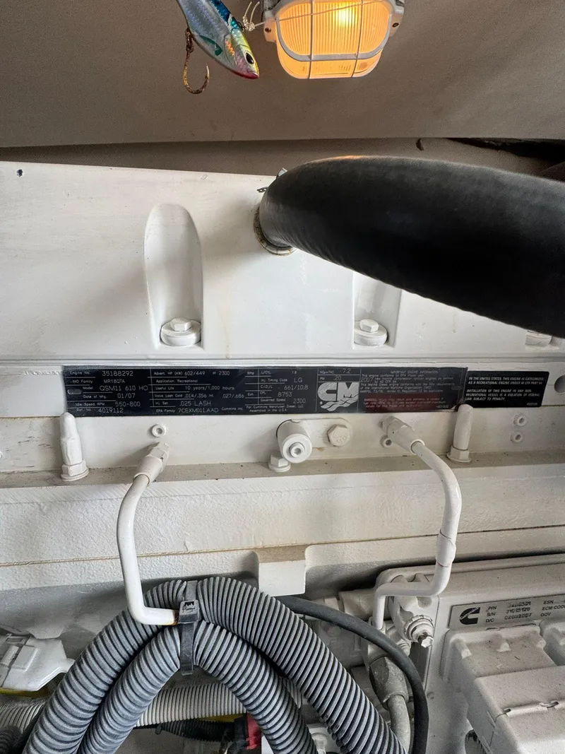 Slide: The Image of Engine compartment of a 2007 Luhrs 41 Express boat, featuring mechanical components and wiring. - 26