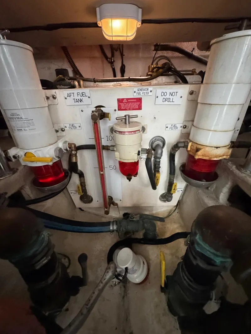 Slide: The Image of Engine room of a 2007 Luhrs 41 Express boat, showing fuel filters and plumbing. - 32