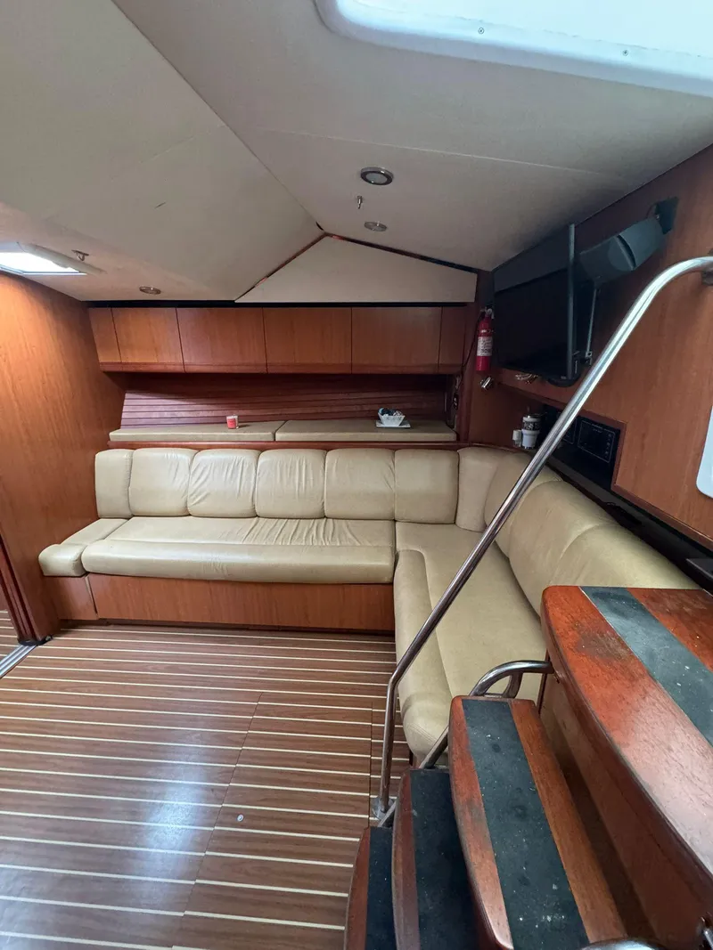 Slide: The Image of 2007 Luhrs 41 Express yacht interior with leather seating and wooden flooring. - 33