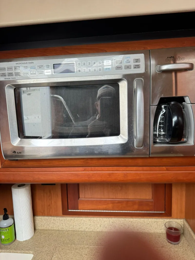 Slide: The Image of Built-in microwave and coffee maker in a 2007 Luhrs 41 Express yacht kitchen. - 34