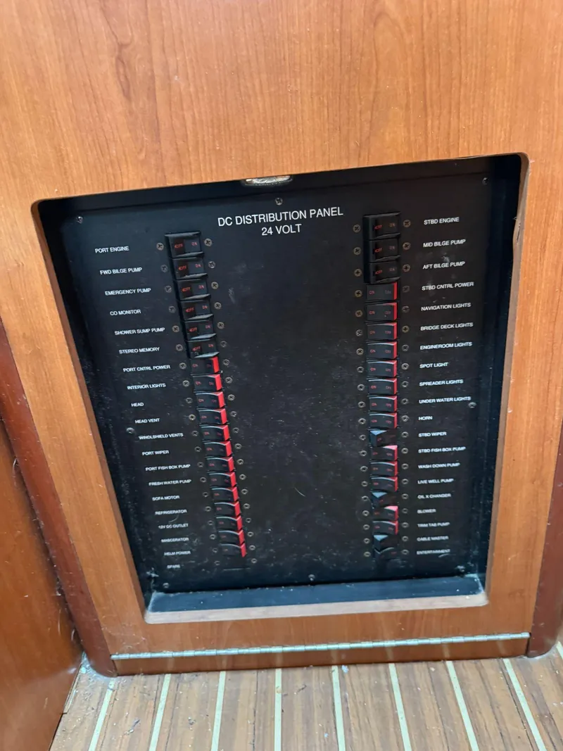 Slide: The Image of 2007 Luhrs 41 Express DC distribution panel, 24-volt system, wooden paneling. - 40