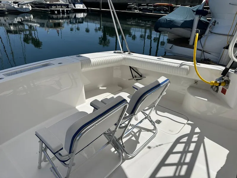 Slide: The Image of 2007 Luhrs 41 Express boat deck with seating, docked in a marina. - 42