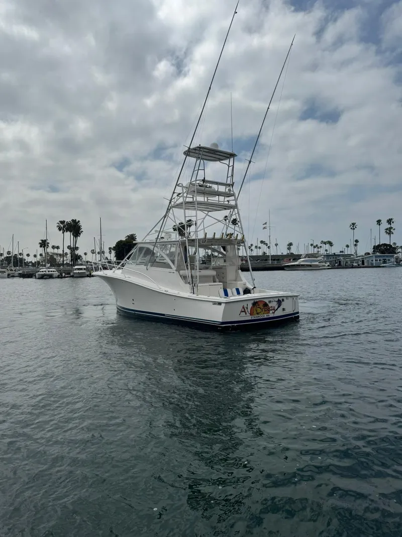 Slide: The Image of 2007 Luhrs 41 Express boat on calm water with cloudy sky background. - 9