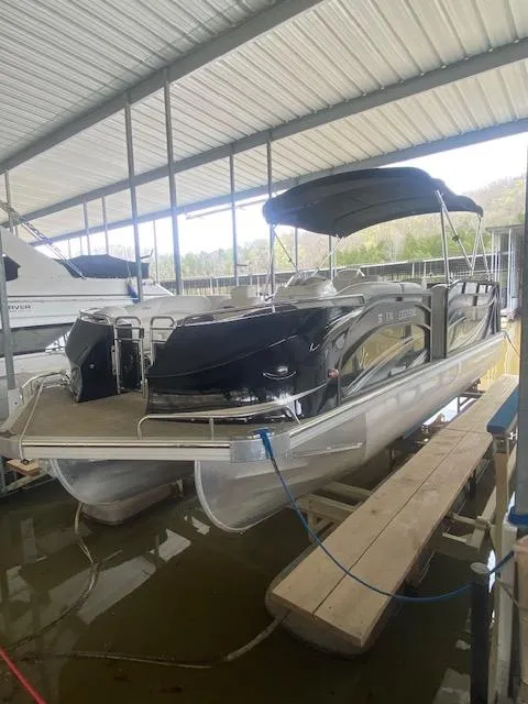 The Image of 2018 JC TriToon boat docked under a covered marina. - 0