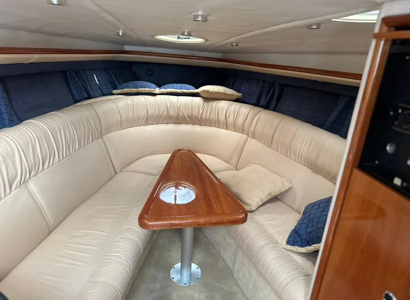 Slide: The Image of Luxurious interior of a 2005 Cobalt 360 boat with plush seating and wooden table. - 13