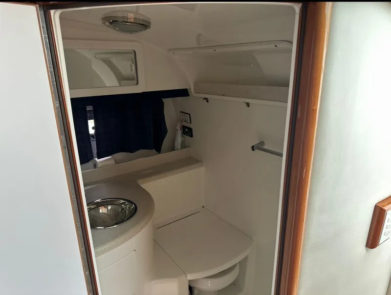 Slide: The Image of 2005 Cobalt 360 boat bathroom interior with sink and toilet. - 14