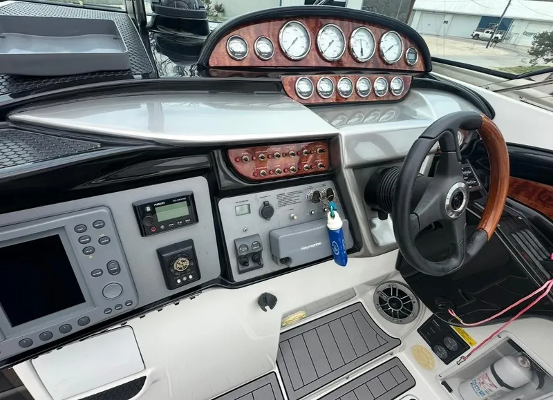 Slide: The Image of 2005 Cobalt 360 boat dashboard with gauges, controls, and steering wheel. - 5