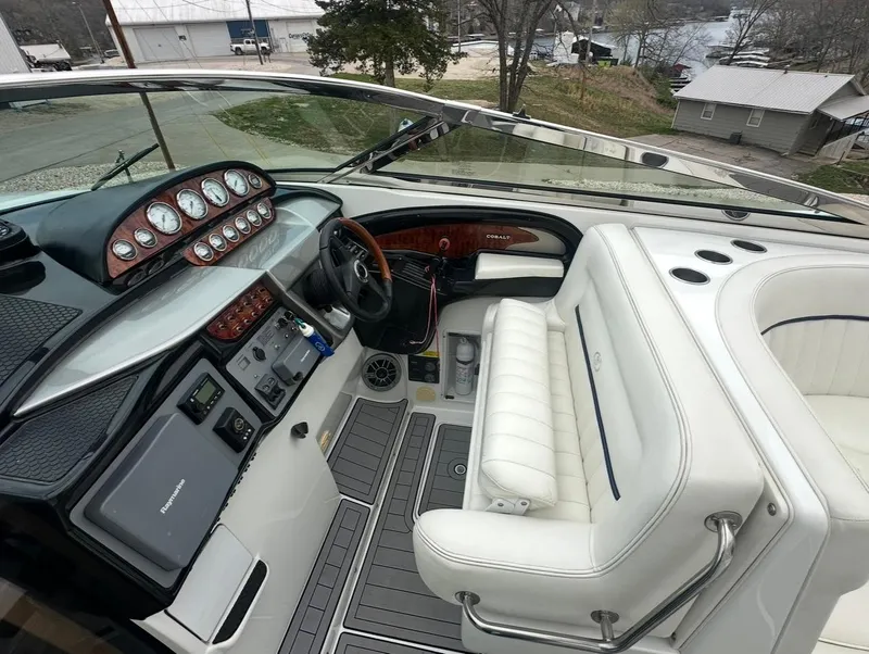 Slide: The Image of 2005 Cobalt 360 boat cockpit with white seating and control panel. - 8