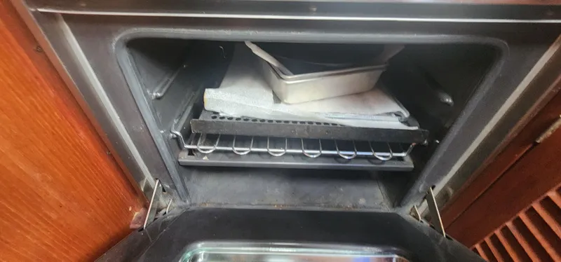 Slide: The Image of Open oven with baking trays inside, aboard a 1982 Tartan 37 sailboat. - 12
