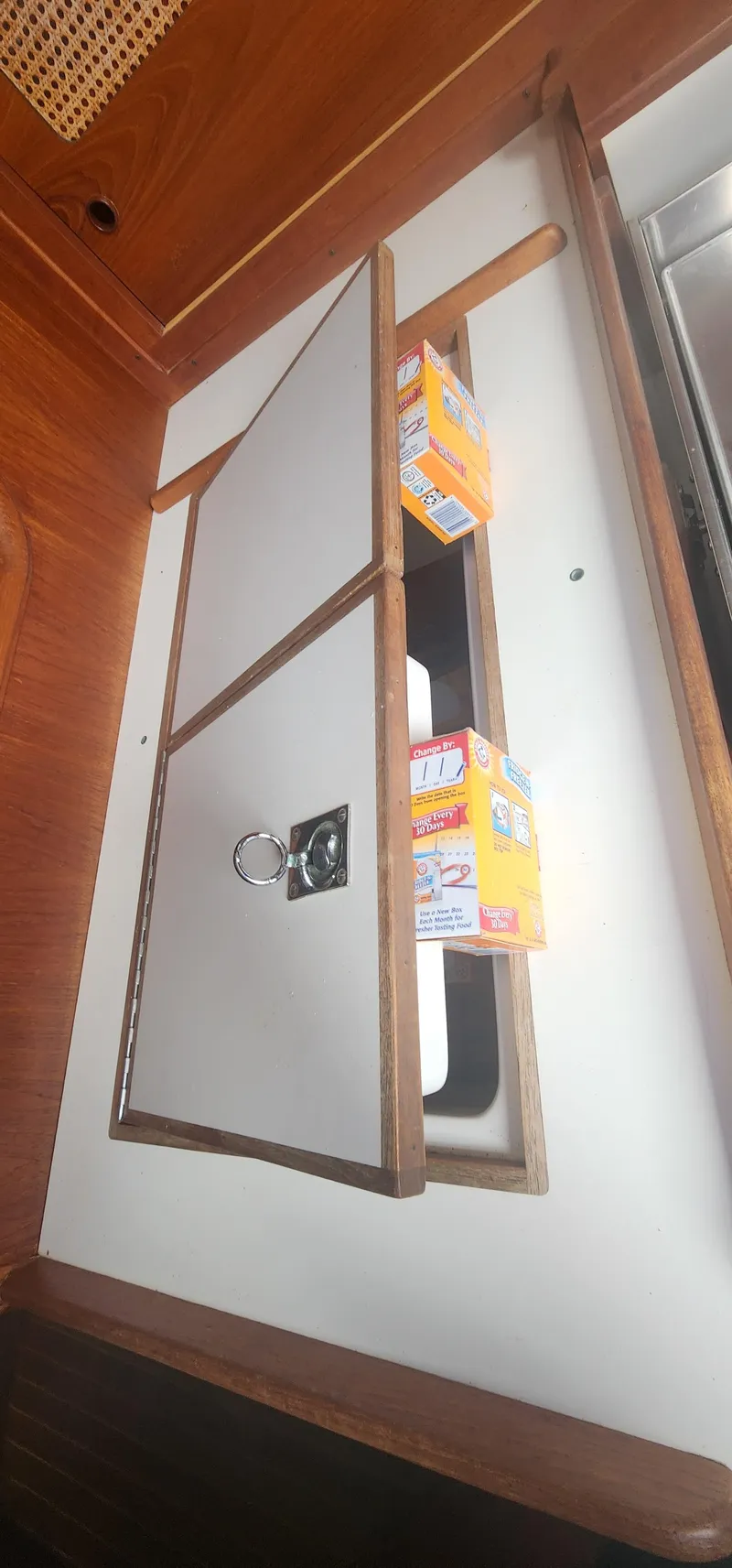 Slide: The Image of Cabinet door in 1982 Tartan 37 yacht interior with baking soda boxes. - 13