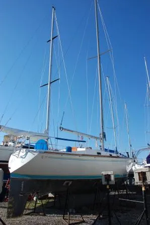 Slide: The Image of 1982 Tartan 37 sailboat on stands, clear blue sky background. - 2