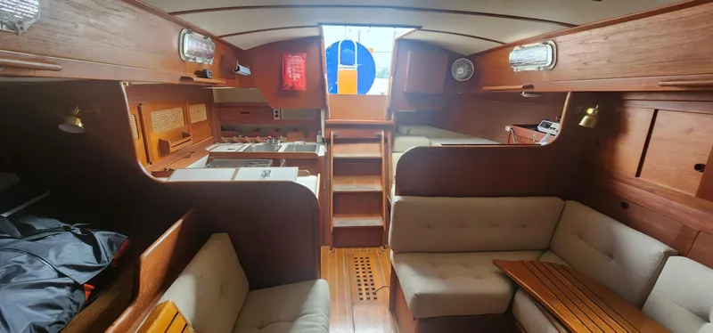Slide: The Image of Interior of 1982 Tartan 37 sailboat with wooden finish and cozy seating area. - 23