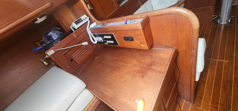 Slide: The Image of Interior of 1982 Tartan 37 sailboat with wooden cabinetry and communication equipment. - 25